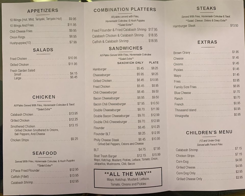 Menu board with wings and sandwiches.